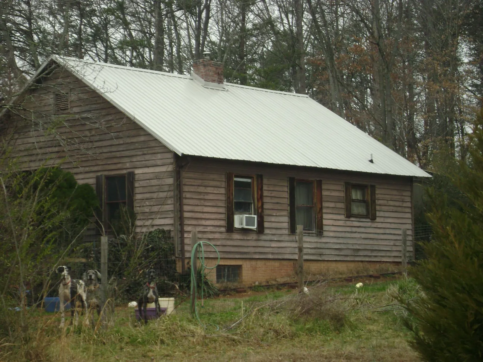 White metal roof on an old wood sided farmhouse, from a Metal Roof Installation job in Starbuck